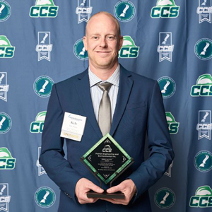 Kyle Bauer holding award