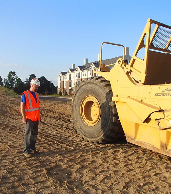 worker standing next to a machine
